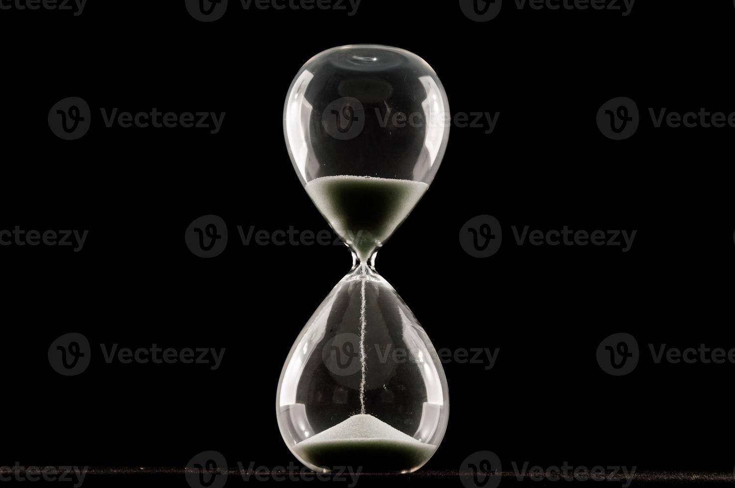 Hourglass on dark background photo