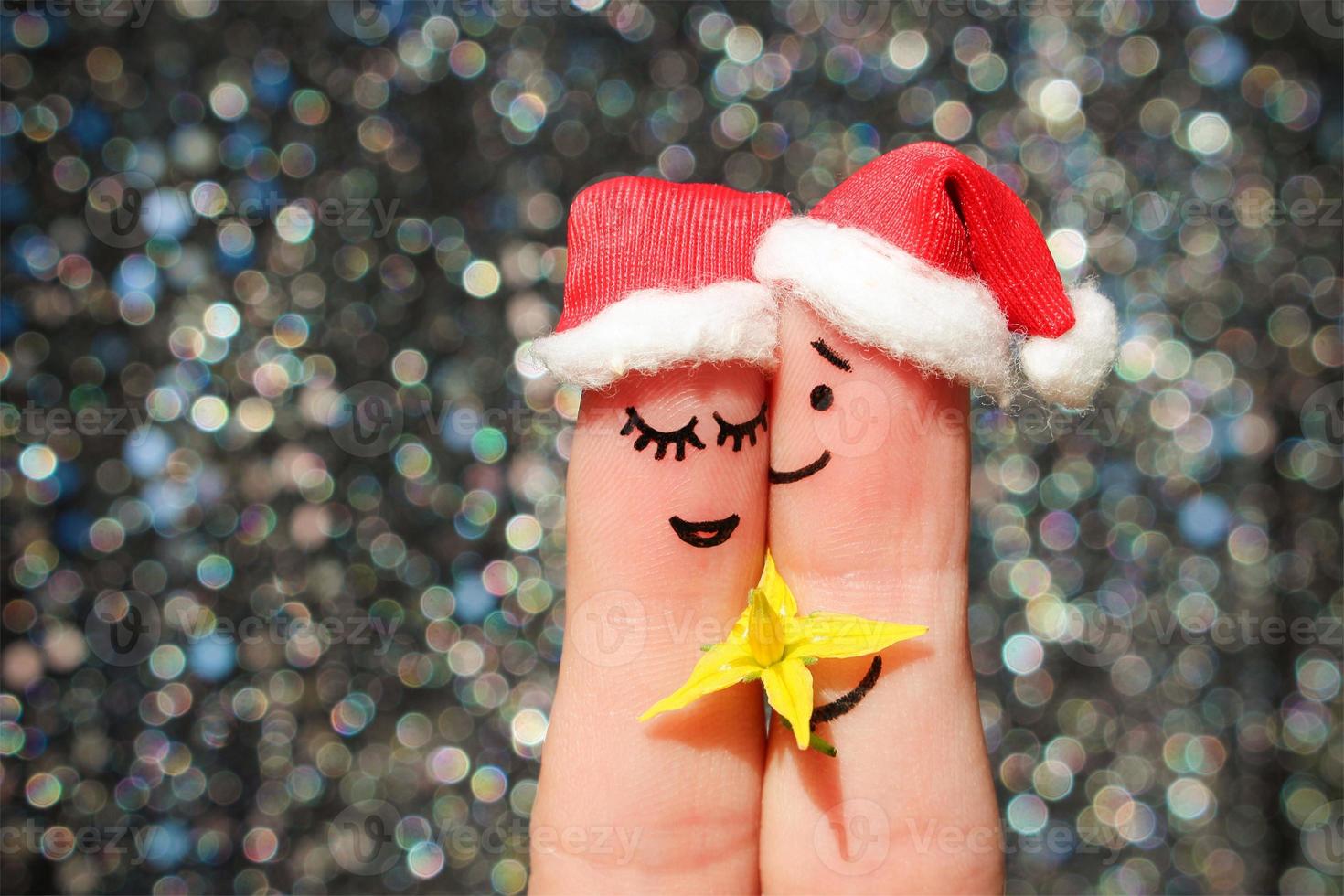 Finger art of a Happy couple celebrates Christmas. Man is giving flowers to a woman. photo