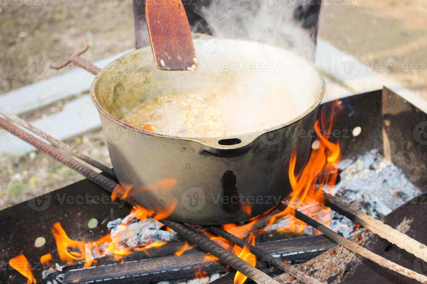 Pilaf cooking on a fire. photo