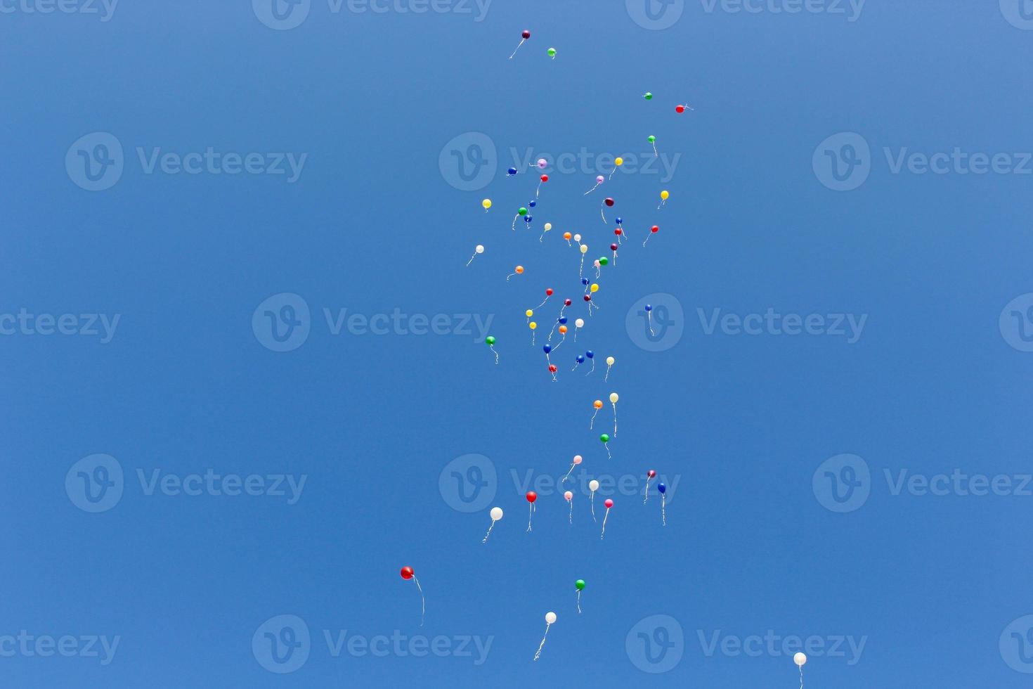 many colored balloons in the blue sky photo