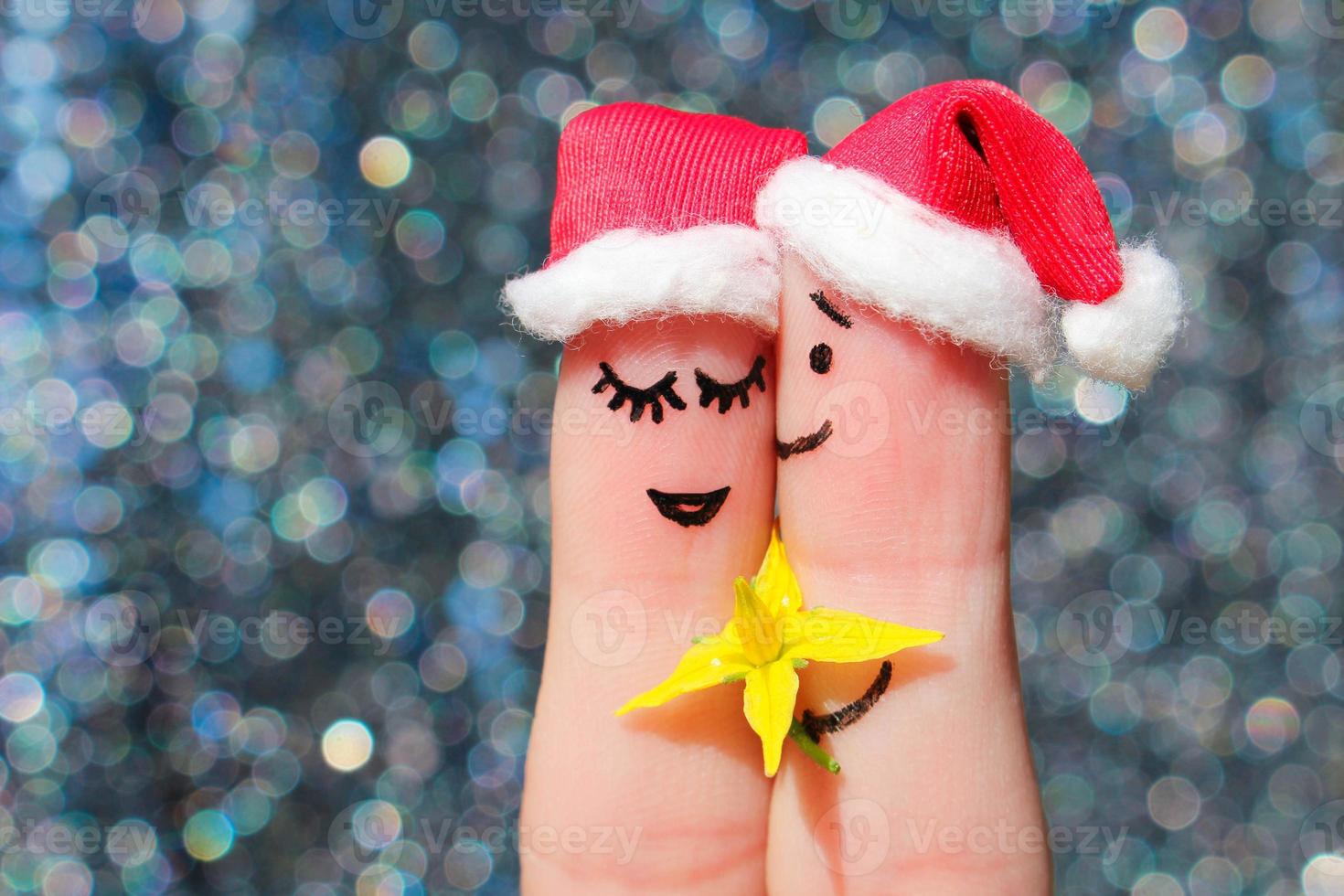 Finger art of a Happy couple celebrates Christmas. Man is giving flowers to a woman. photo