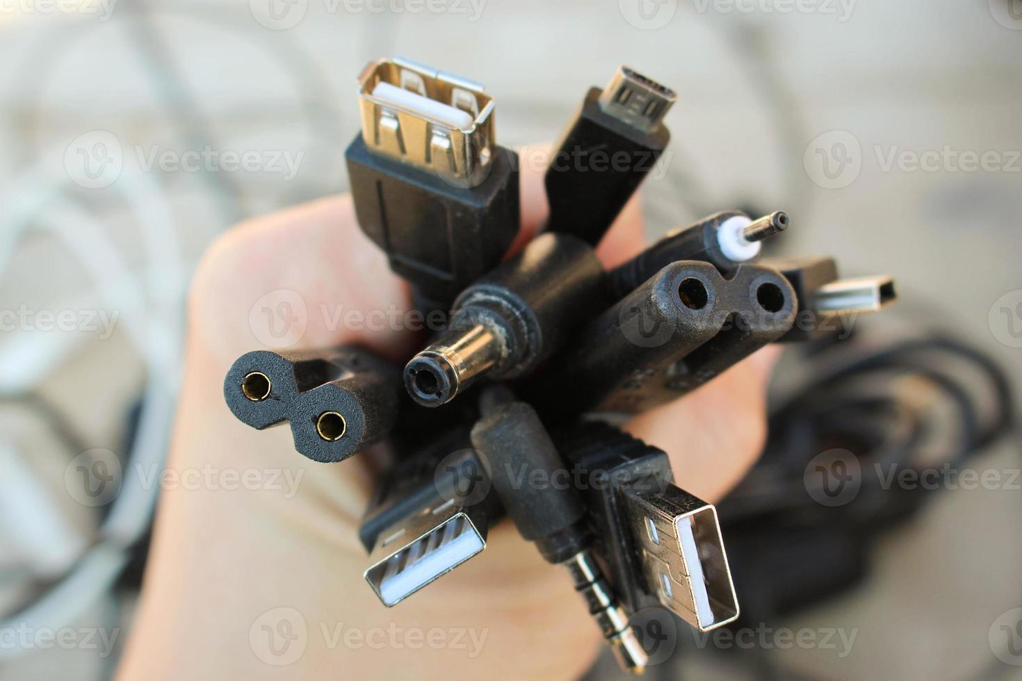The hand holds universal recharger heads photo