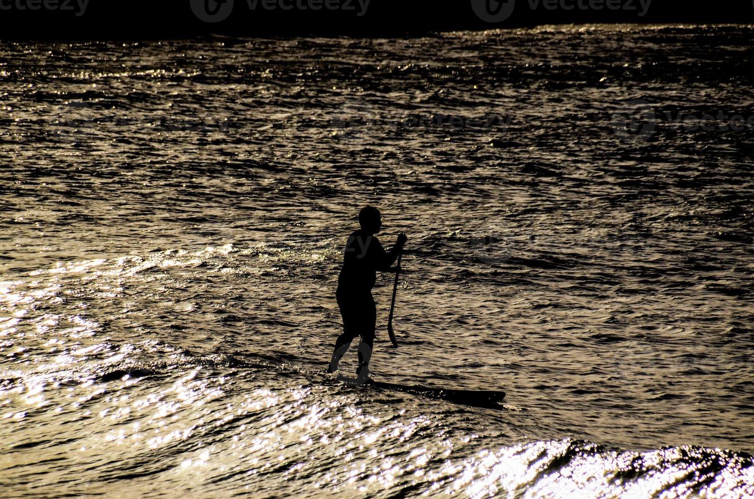 Silhouette of a surfer photo