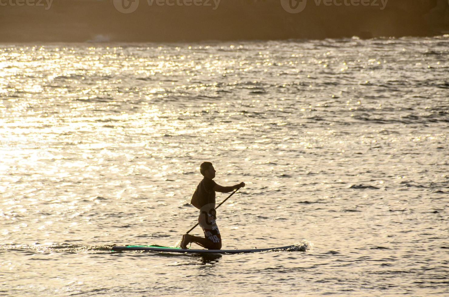 Silhouette of a surfer photo