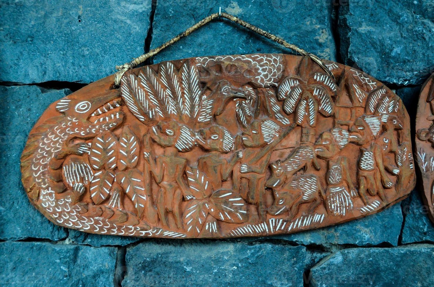 Decorated plate on a stone wall photo