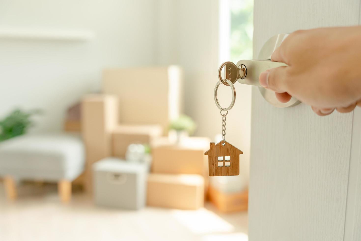 Moving house, relocation. Man hold key house keychain in new apartment. move in new home. Buy or rent real estate. flat tenancy, leasehold property, new landlord, investment, dwelling, loan, mortgage. photo