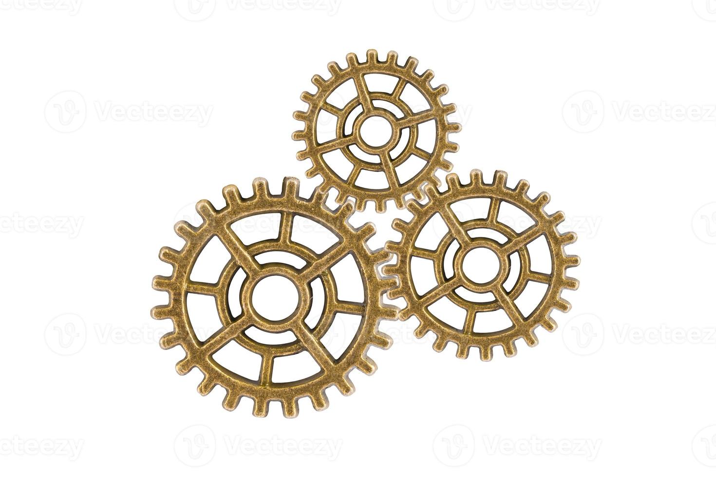 Gear and cogs wheels isolated on a white background, clock mechanism, brass metal engine industrial. photo