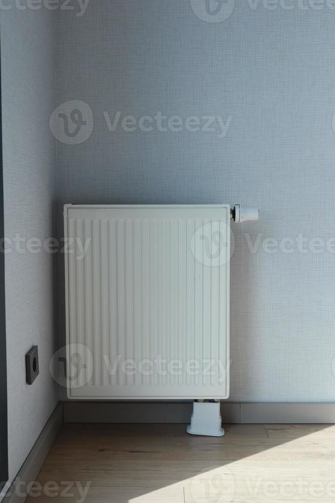 heating radiator under window in the room photo