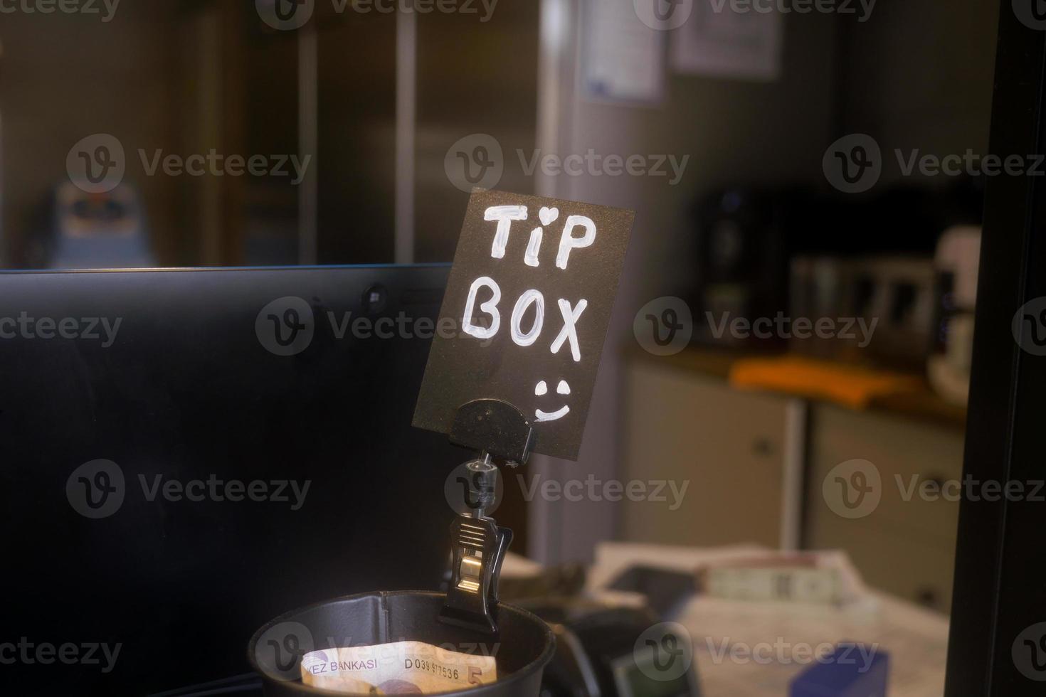 close up of a tips box in a cafe photo