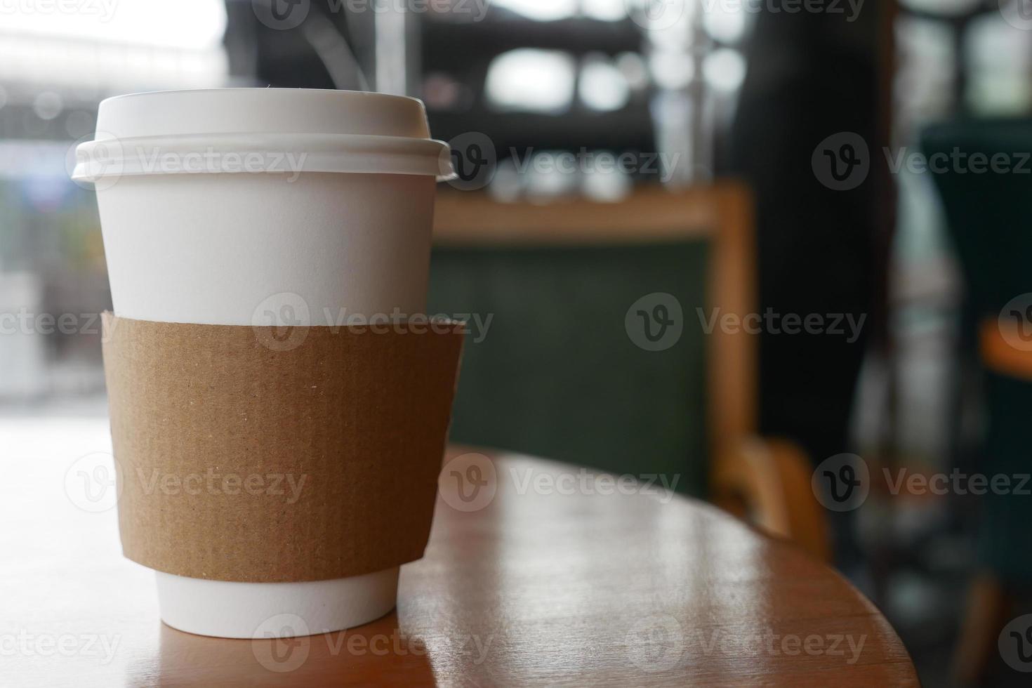 take away paper coffee cup o on cafe table photo