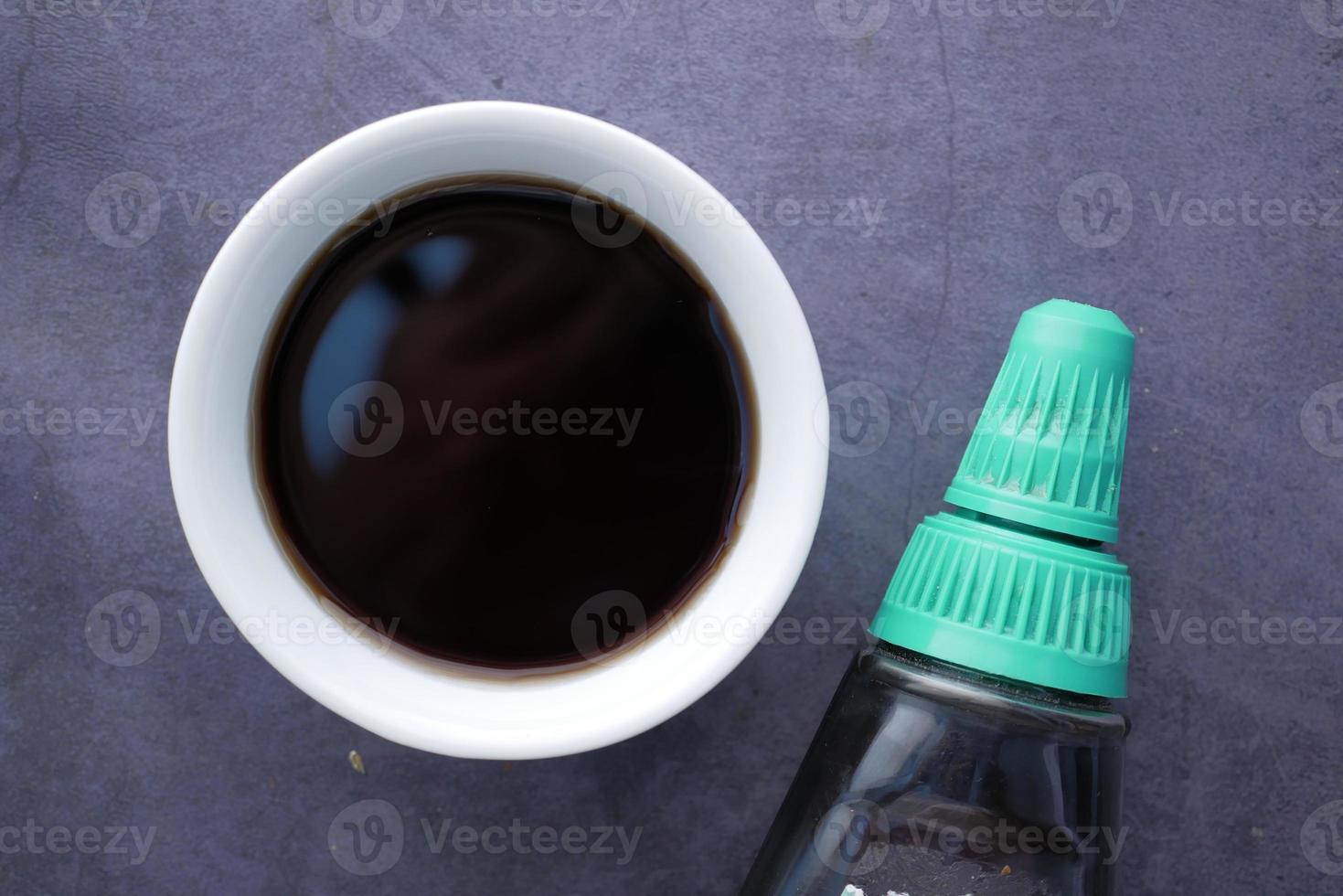 Bottle of maple syrup pouring close up photo