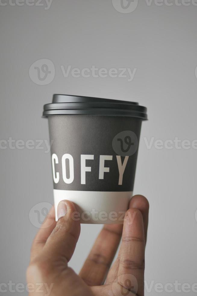 hand with cardboard cup or disposable cup f photo