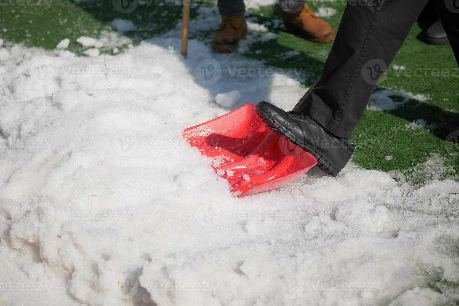 men using Red blurry snow shovel. photo