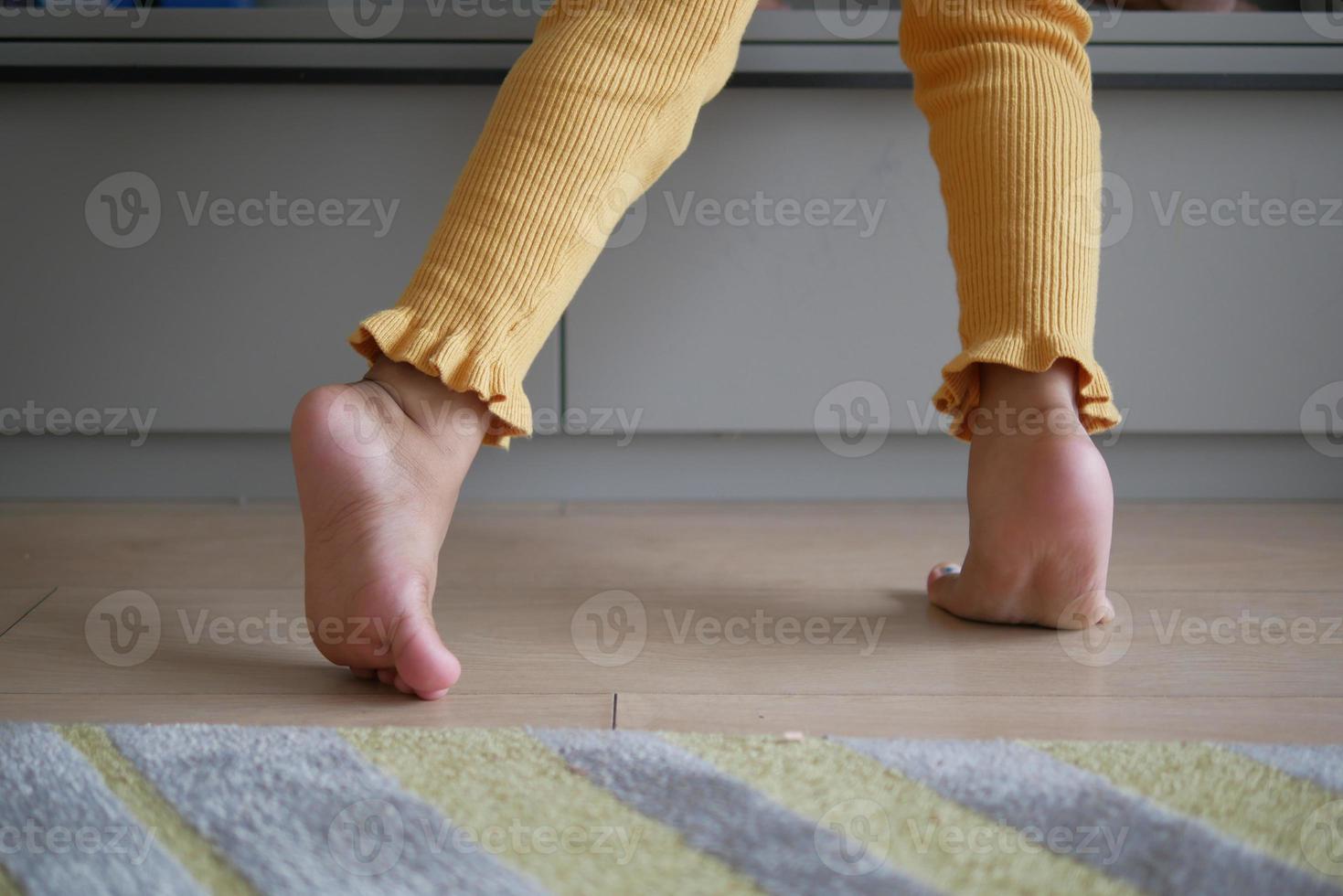 low angle view of A child walking on tiptoes photo