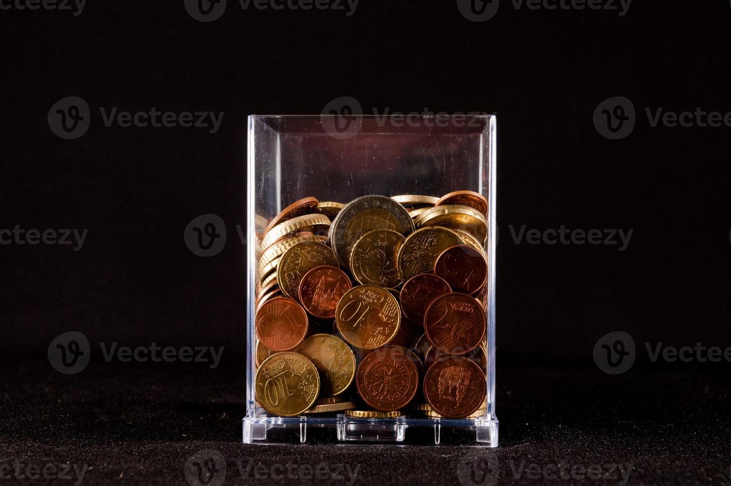 Transparent glass with coins photo