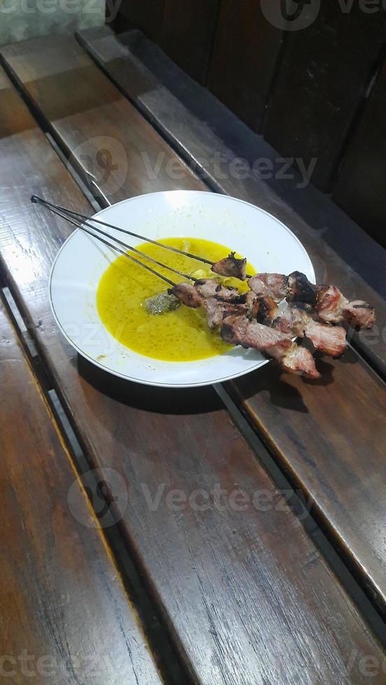 klatak satay made from young goat meat, served with yellow curry soup photo