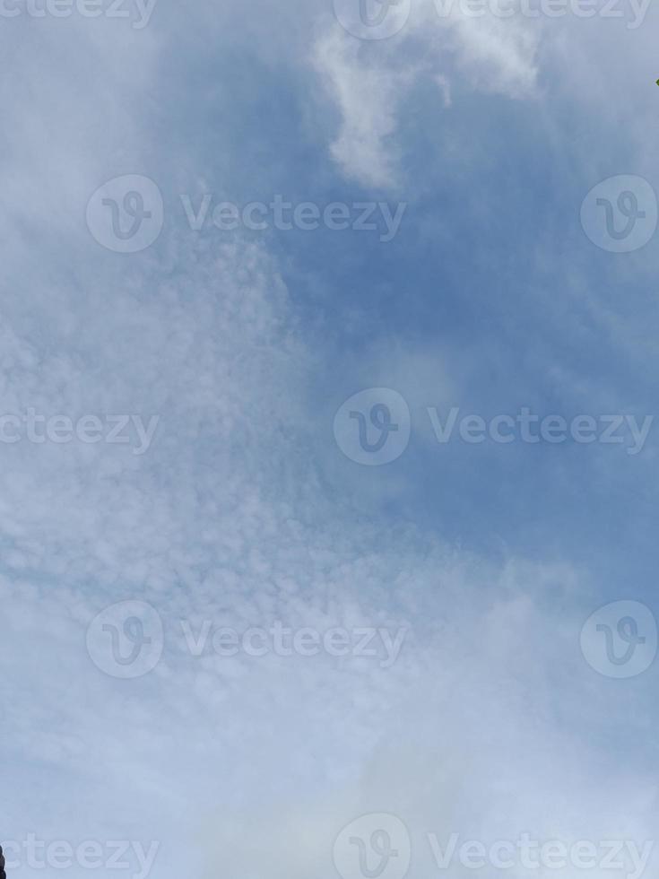 Beautiful white clouds on deep blue sky background. Large bright soft fluffy clouds are cover the entire blue sky. photo