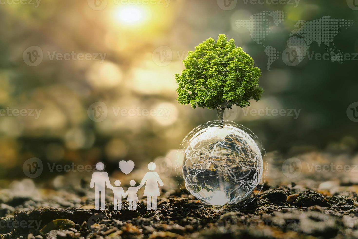 concept idea eco environment. tree growing on globe glass with world map and family icon in nature photo