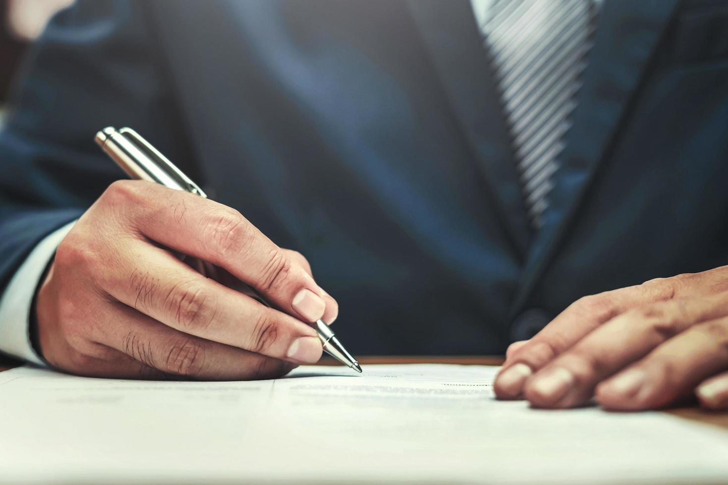 businessman writing on paper report in office concept photo