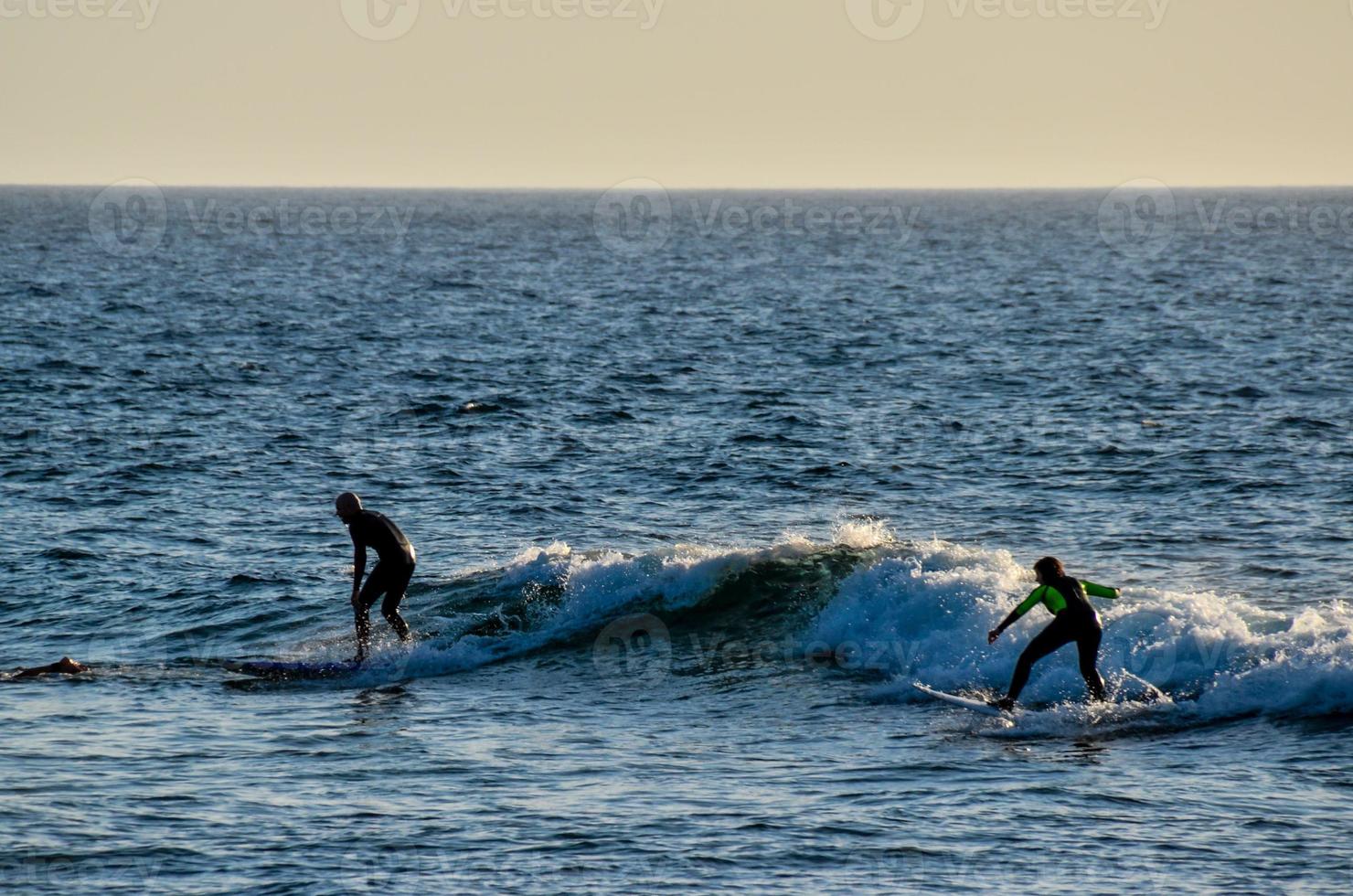 Two surfers catching the wave photo