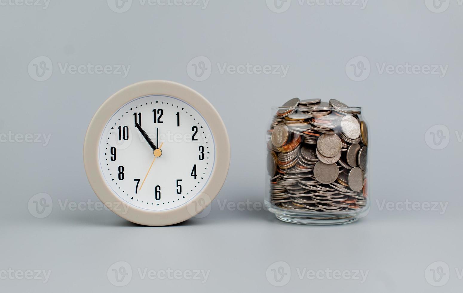 Coins and an alarm clock savings concept finance finance business photo