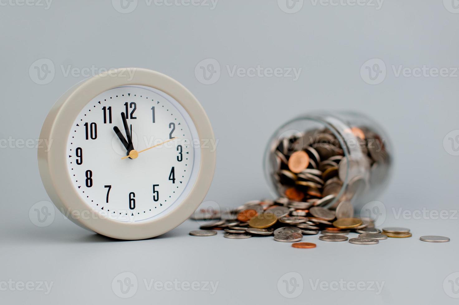 Coins and an alarm clock savings concept finance finance business photo