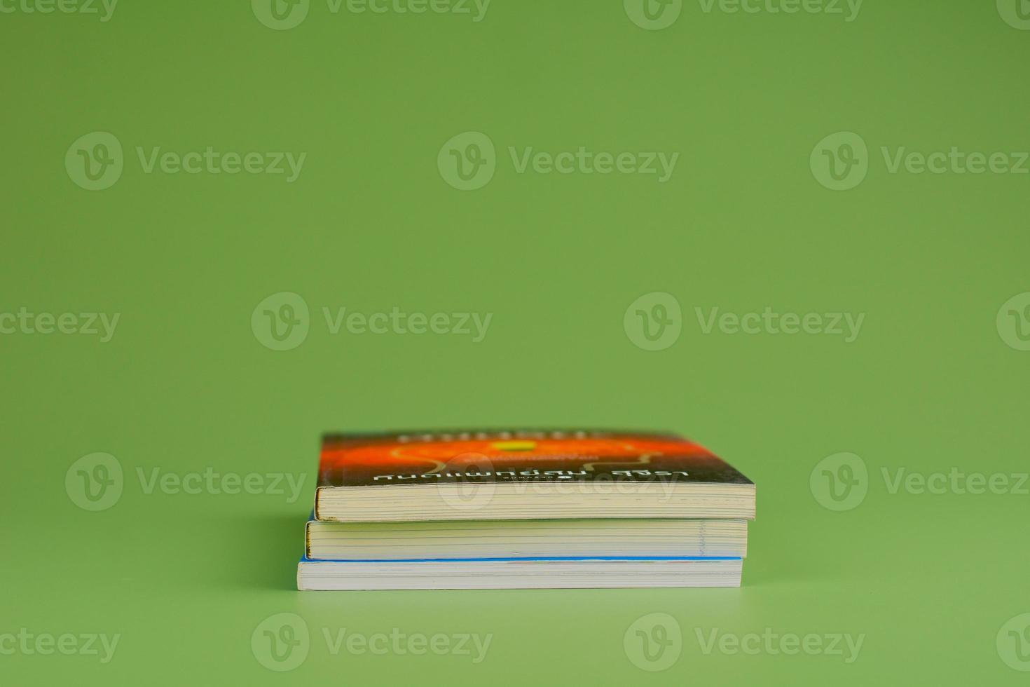 Books. Stack of books stacked on light green background. Reading. Reading concept. and collection of books photo