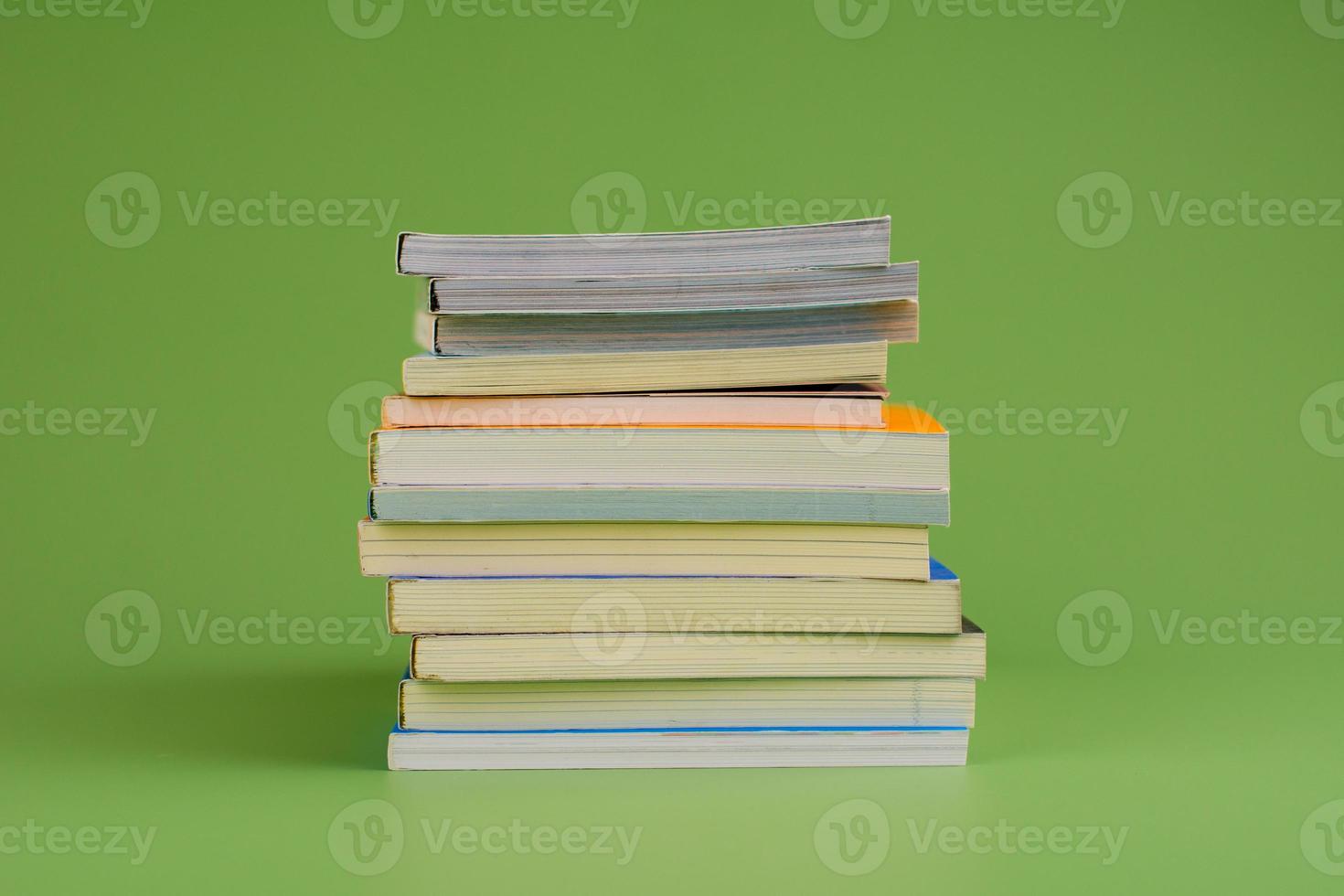 Books. Stack of books stacked on light green background. Reading. Reading concept. and collection of books photo