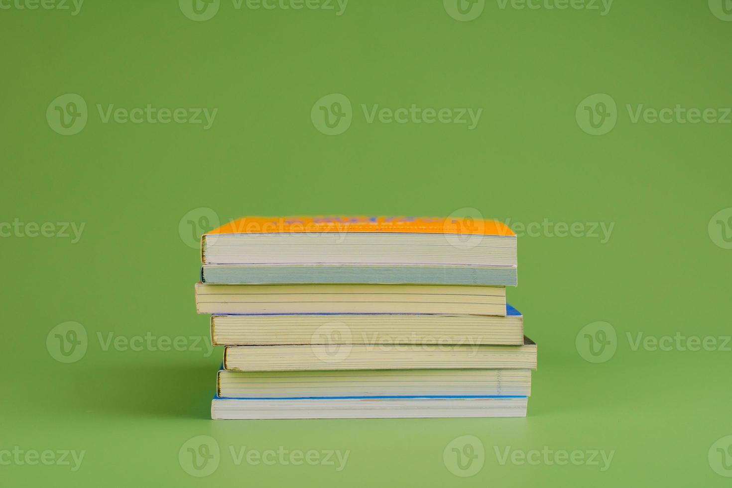 Books. Stack of books stacked on light green background. Reading. Reading concept. and collection of books photo