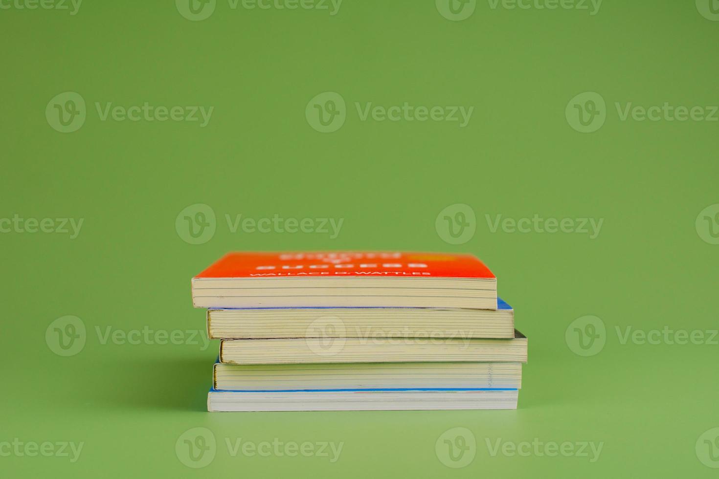 Books. Stack of books stacked on light green background. Reading. Reading concept. and collection of books photo