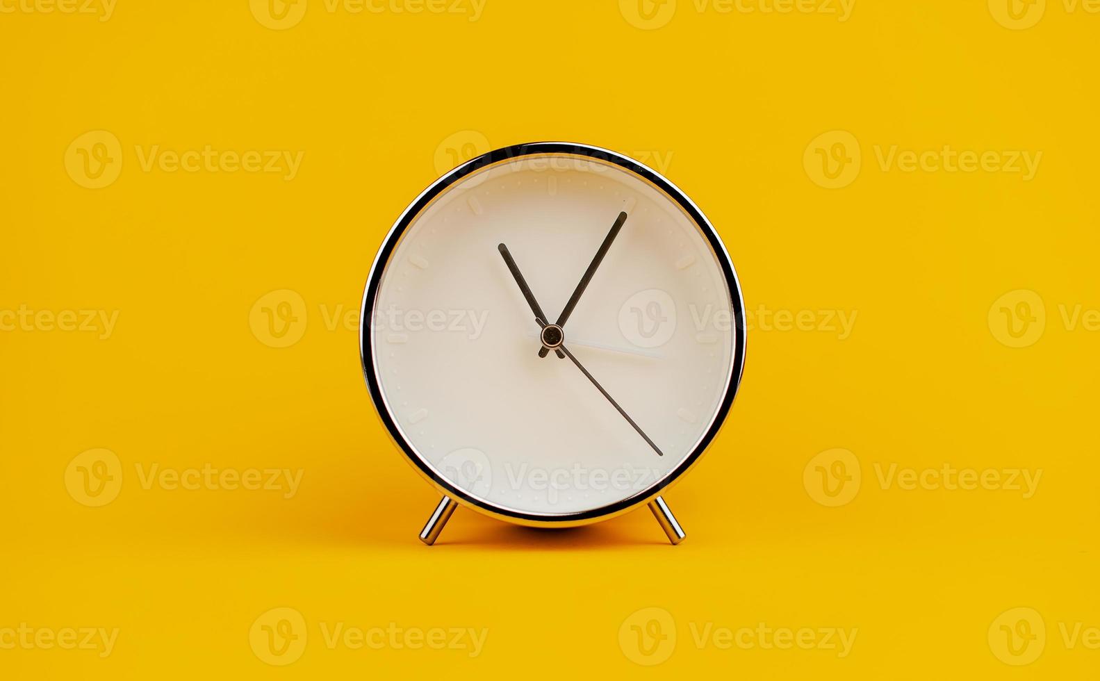 white clock on yellow background concept of time Time planning photo