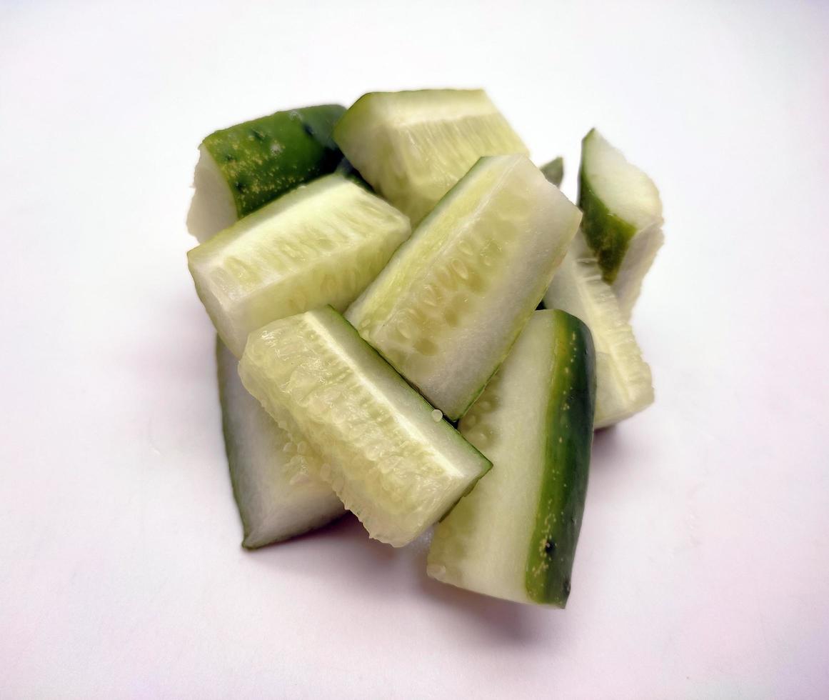 Cubed cucumber slices isolated in white background photo