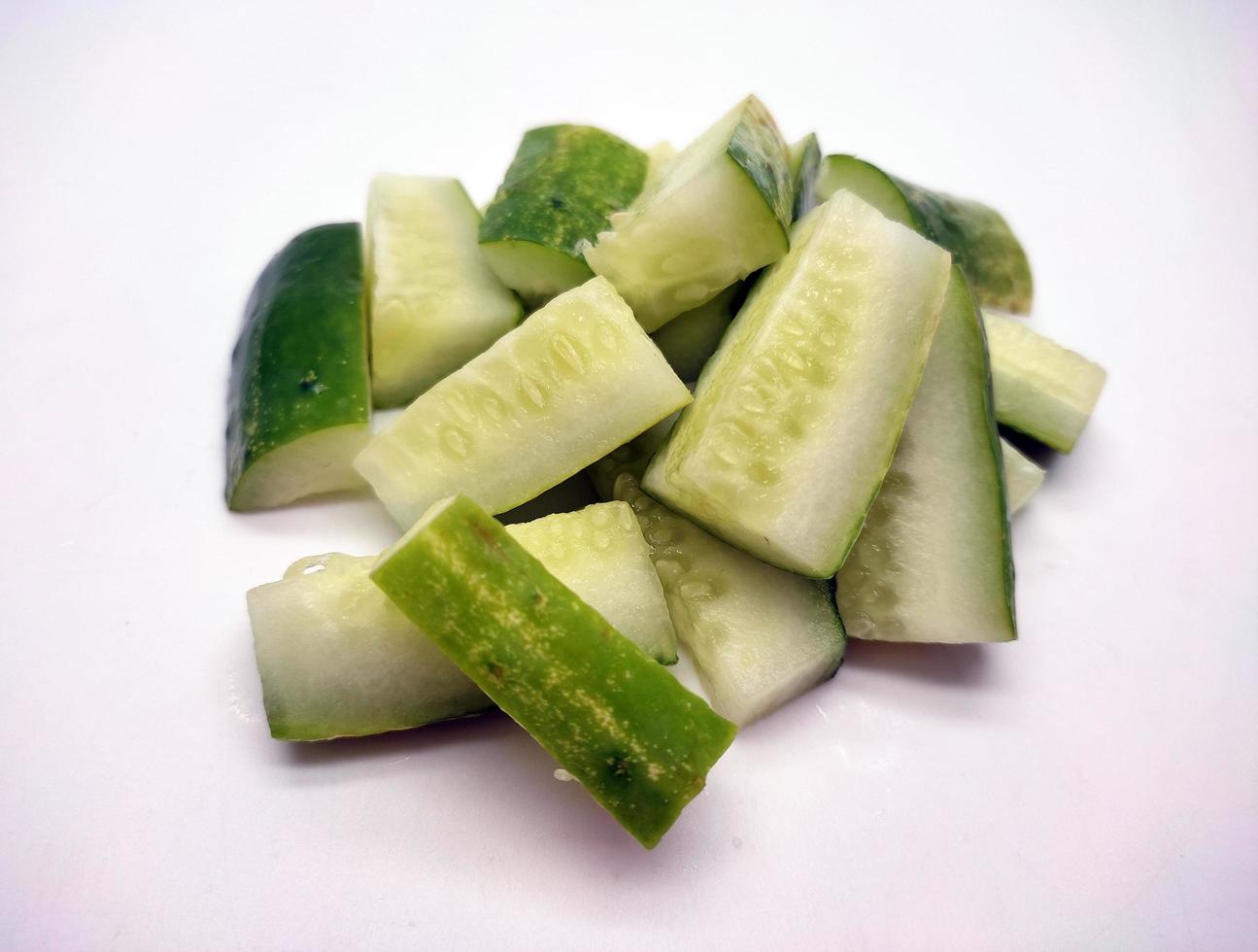 Cubed cucumber slices isolated in white background photo