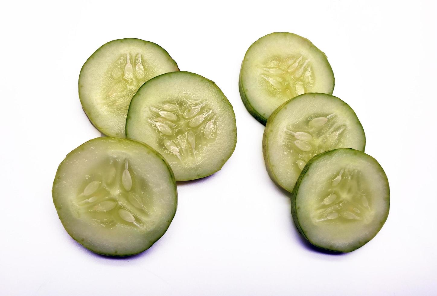 Slices of cucumbers isolated in white background photo