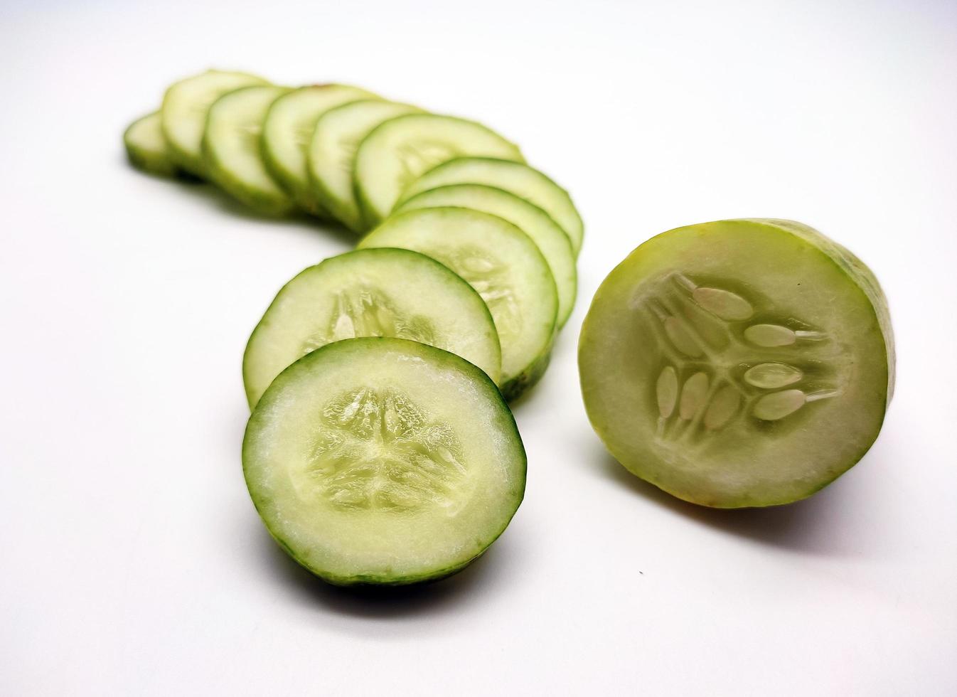 Slices of cucumbers isolated in white background photo