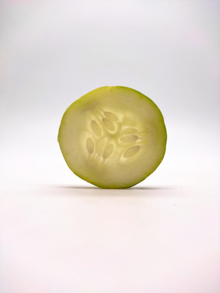 Round cucumber slice isolated in white background photo