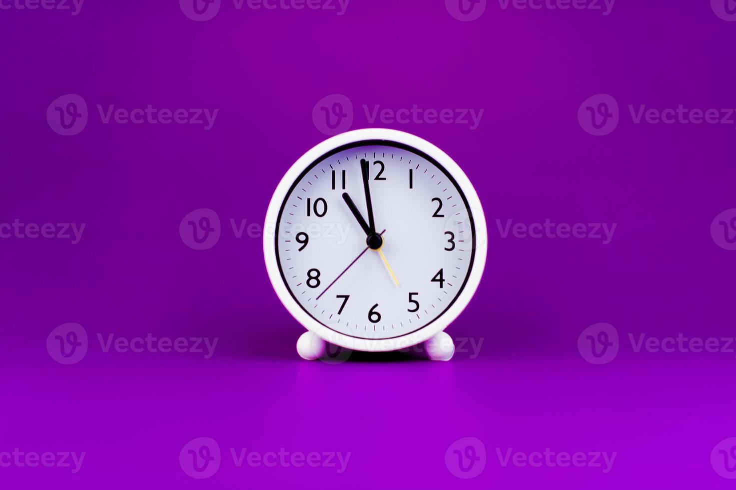 White clock on purple background, time concept Time planning photo