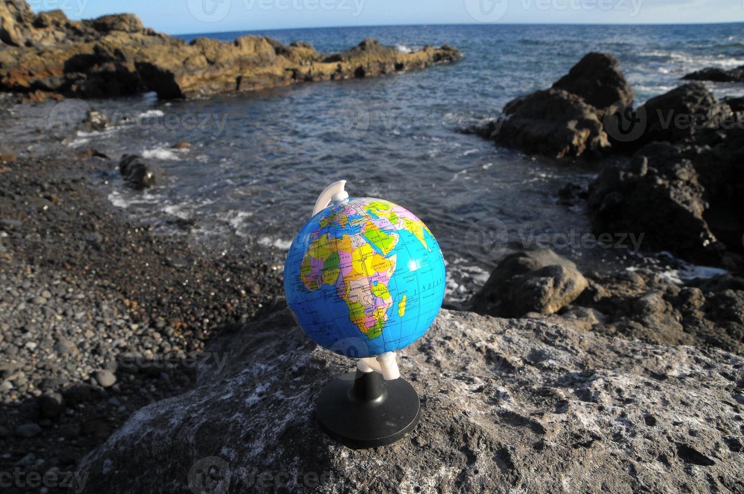 Earth globe on a rock photo