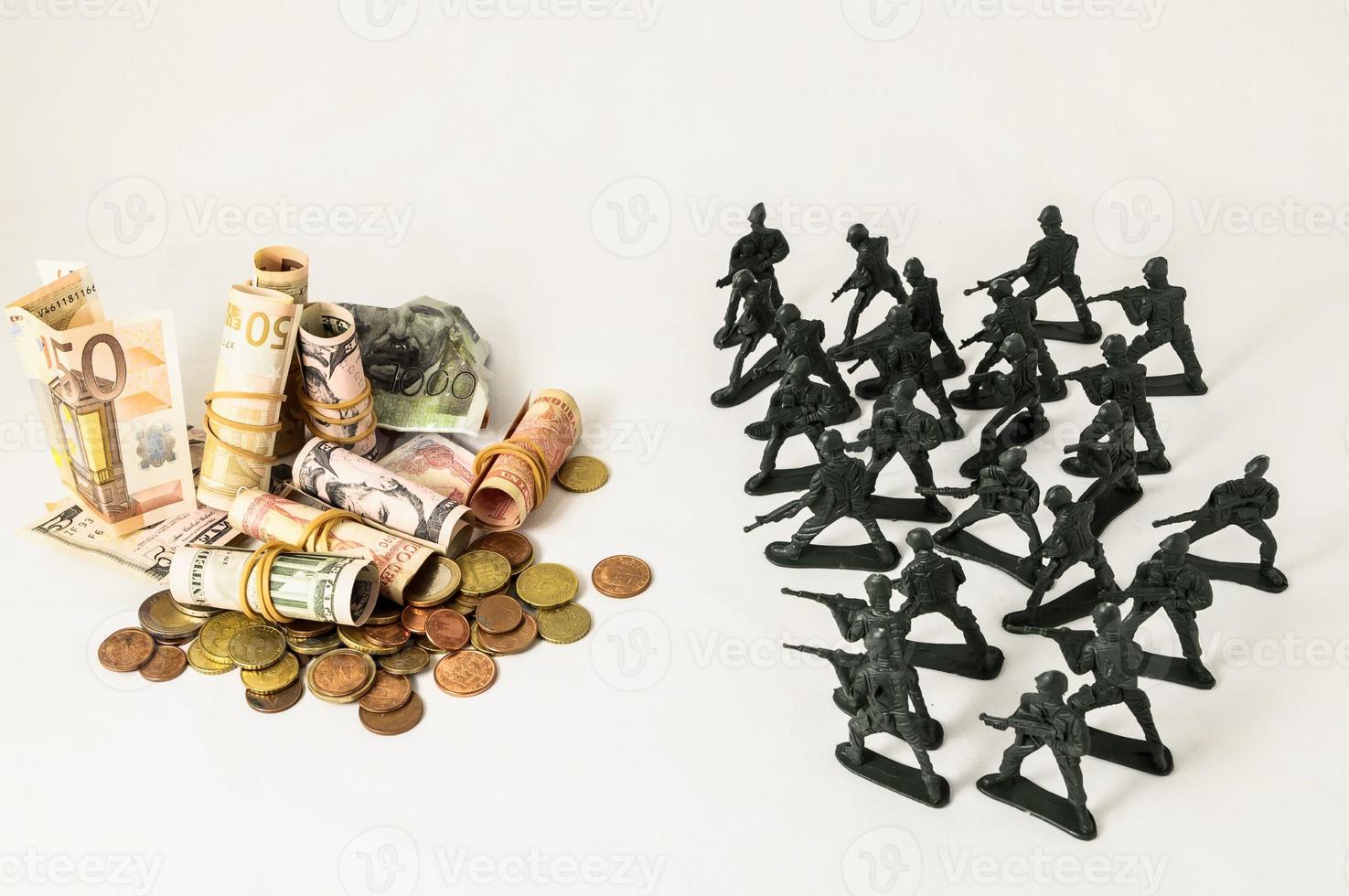 War concept with money and miniature soldiers photo