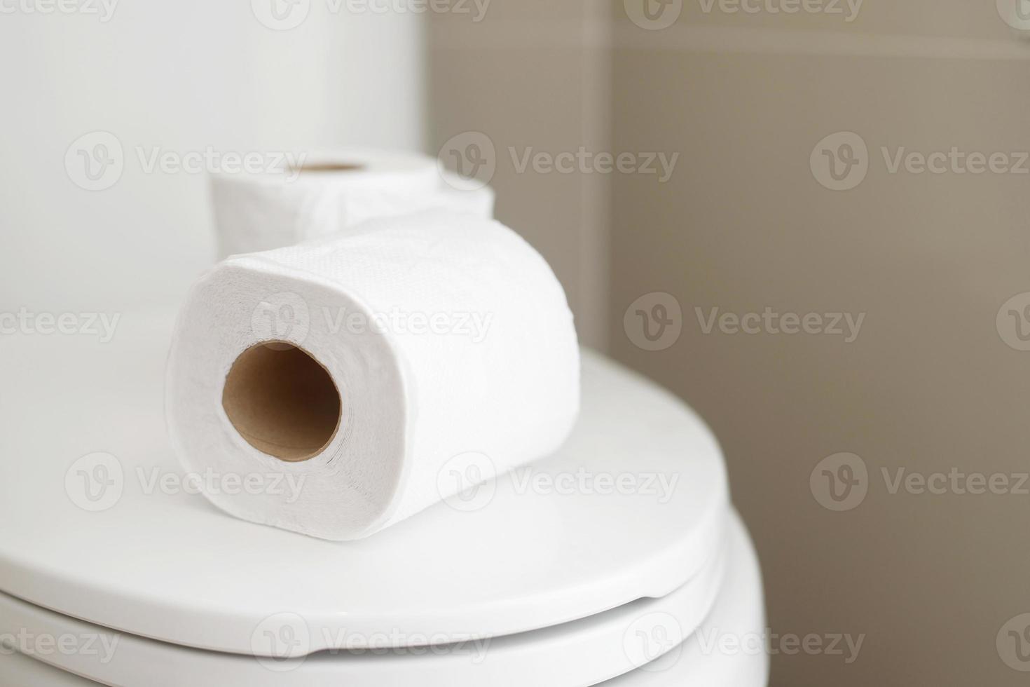 The tissue paper was placed on the toilet bowl in the bathroom. photo