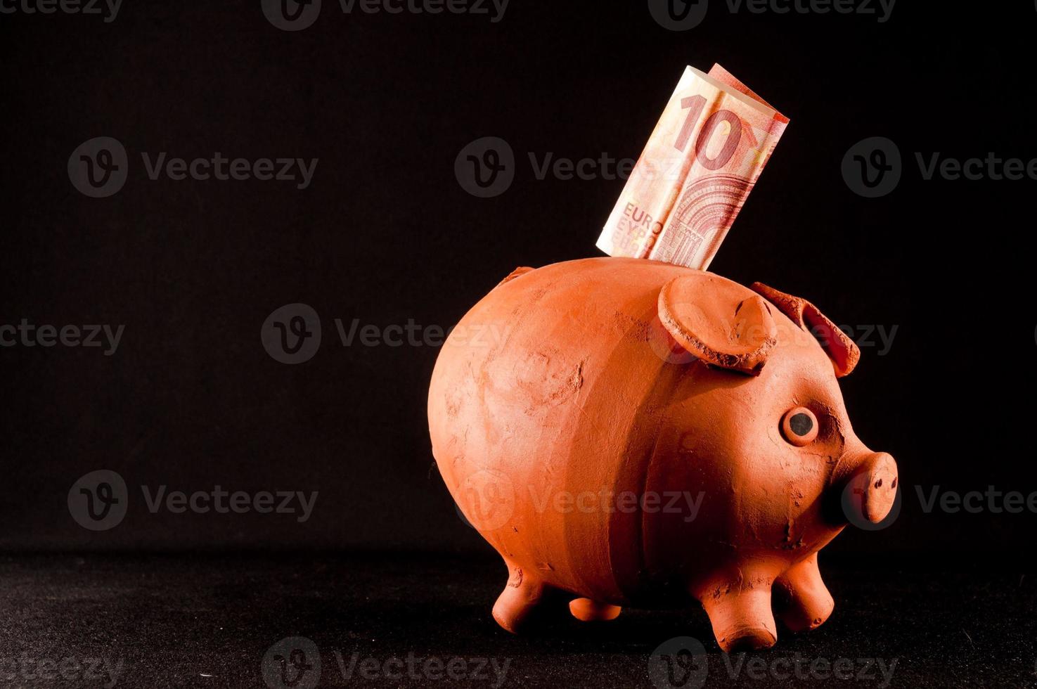 Piggy bank isolated on black background photo