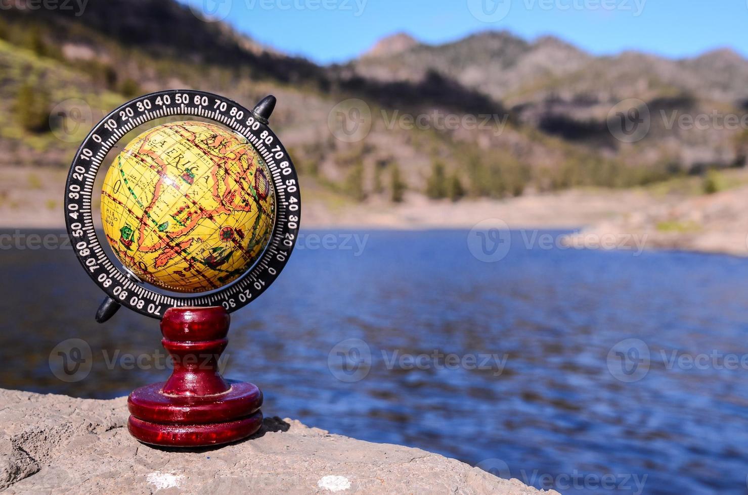 Globe on a rock photo