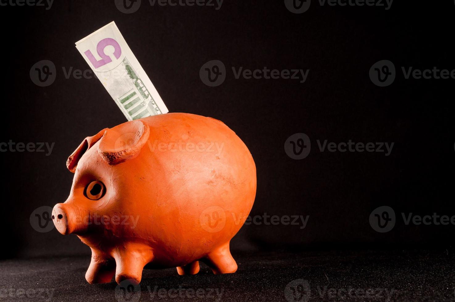 Piggy bank isolated on black background photo
