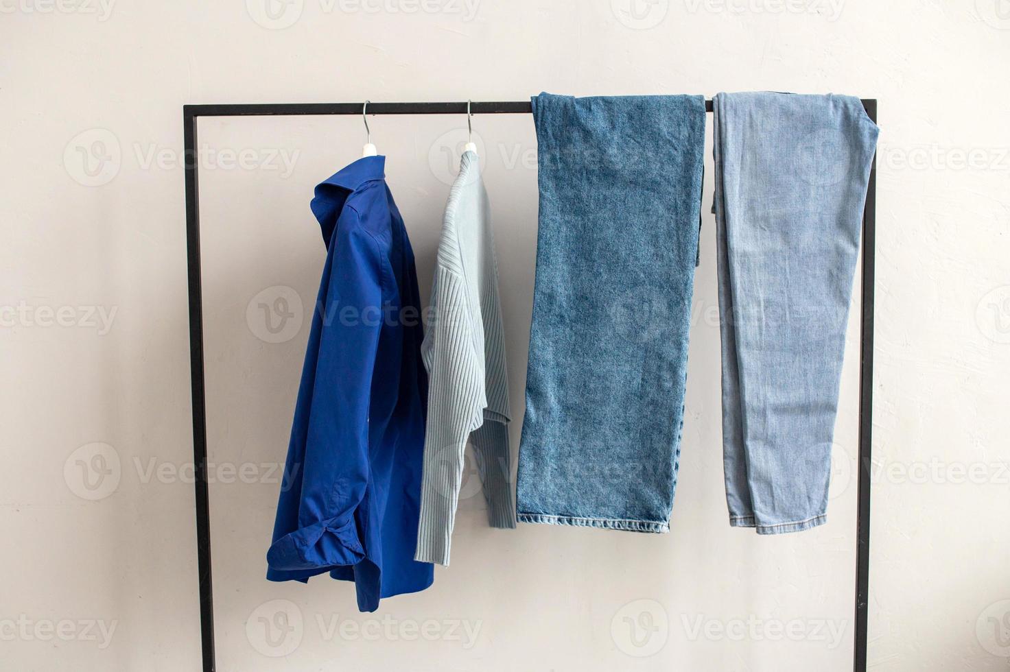 There are blue things hanging on the hanger. A set of blue clothes photo