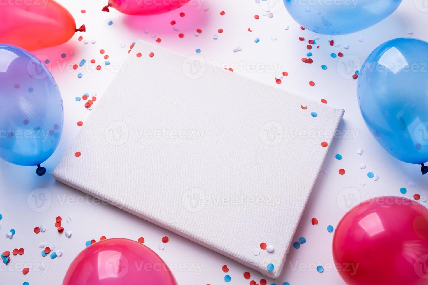 Blank white canvas frame for mockup design with colorful balloons and confetti photo