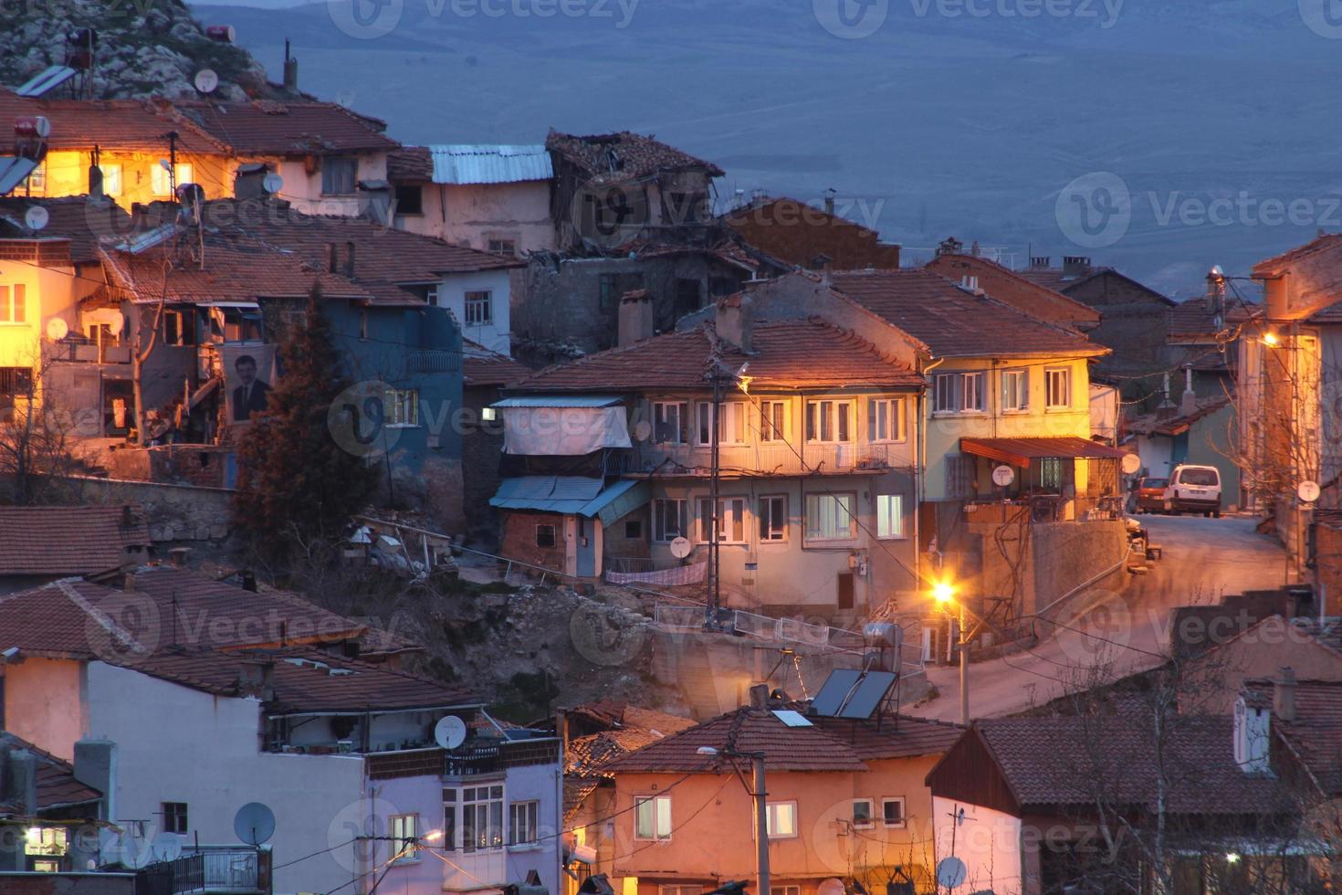 houses with a light on in the middle of the night photo