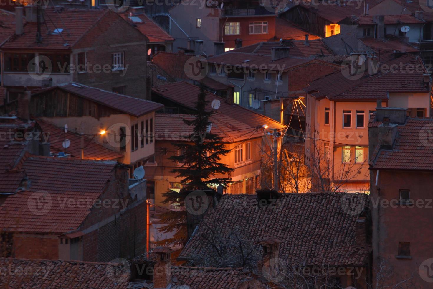 houses with a light on in the middle of the night photo