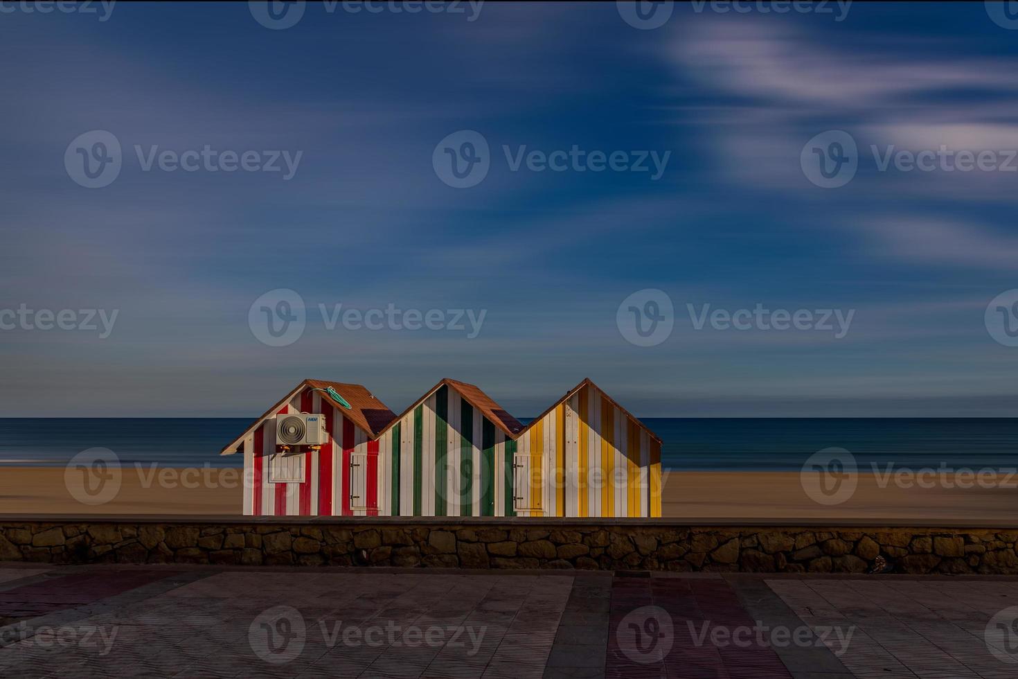 peaceful seaside landscape with three colorful wooden houses beach and vacation photo