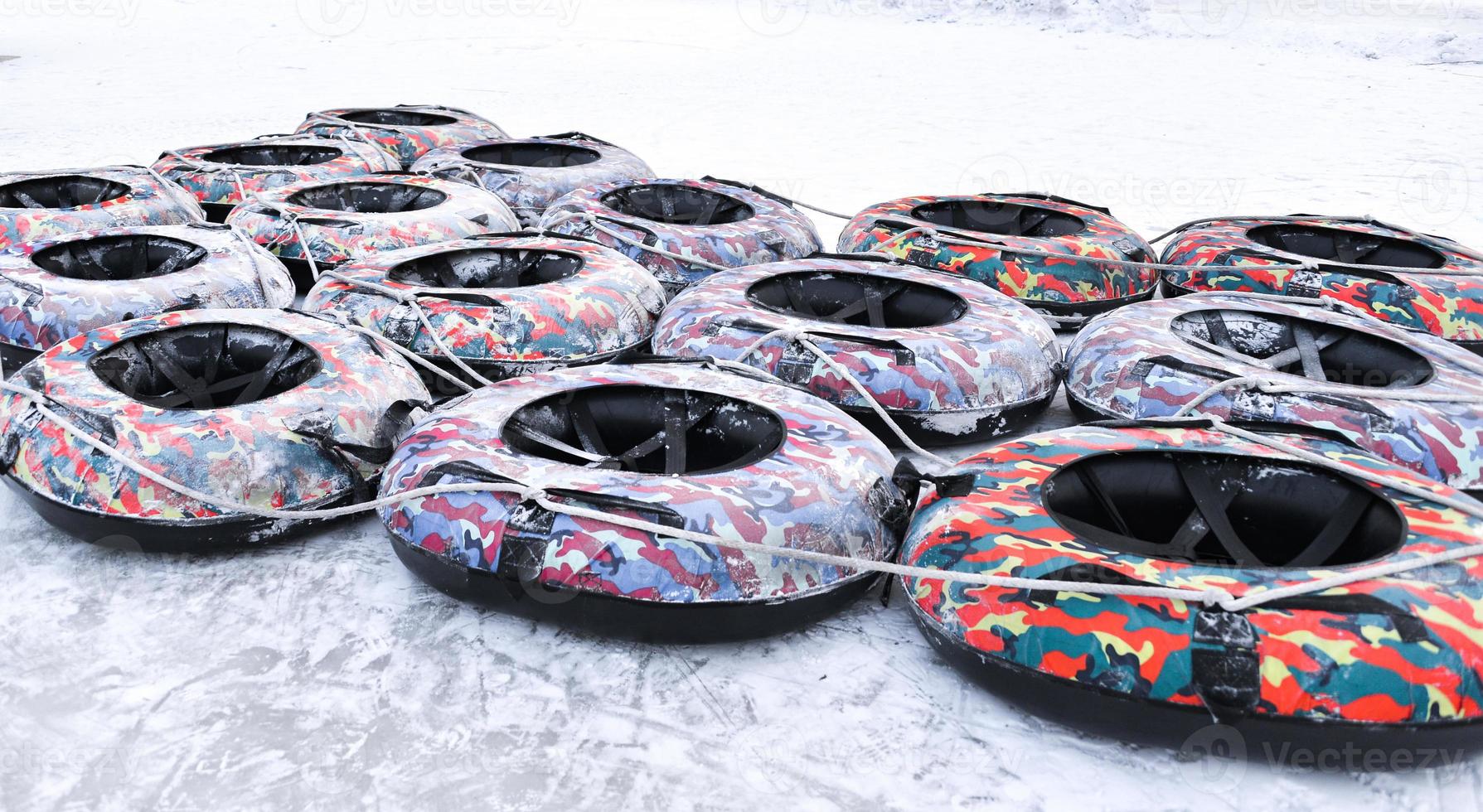 Inflatable sledges on ice in winter photo