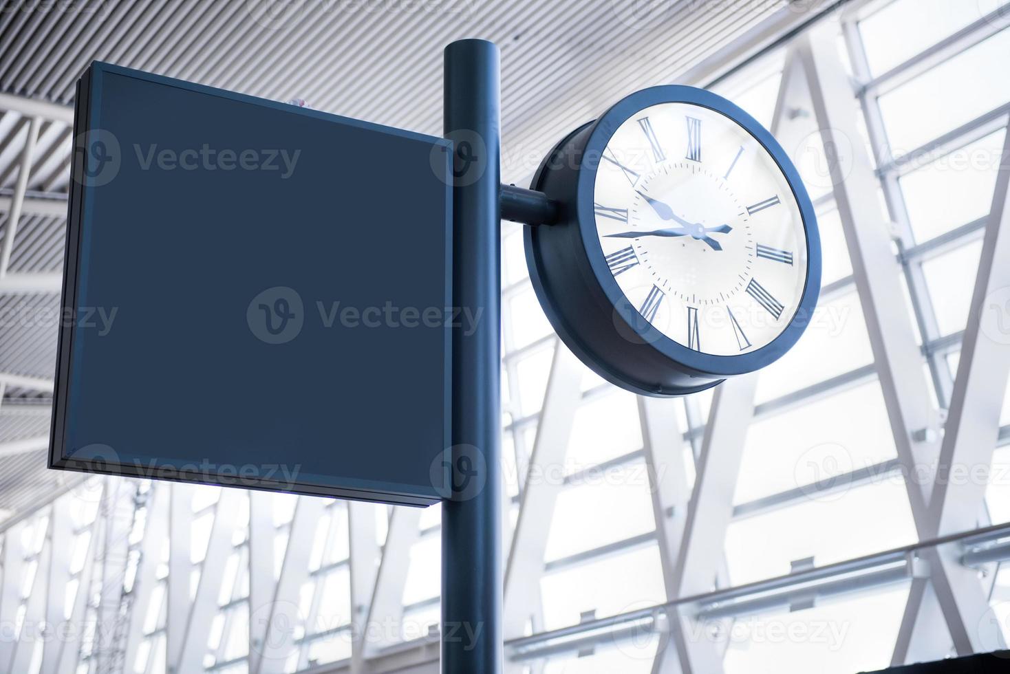 Clock at an international airport and sign photo